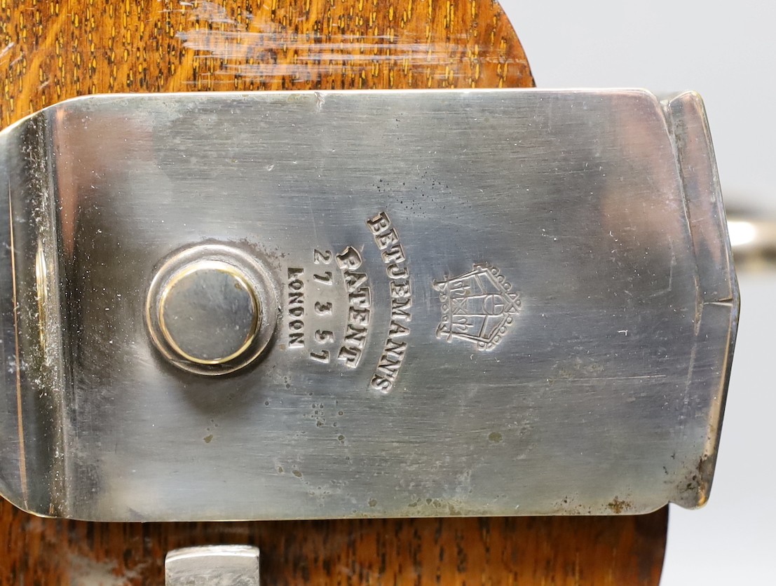 A Betjemann’s patent twin bottle oak and plated tantulus- no key, 32 cms high